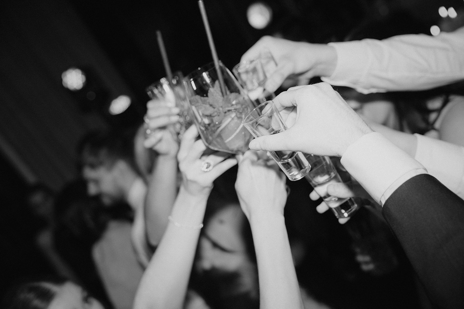 Guests raising glasses during a lively Tuscany wedding reception party