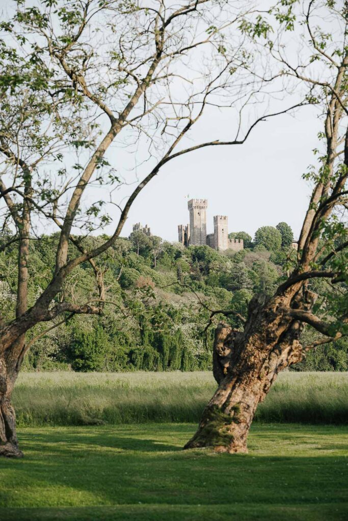 Medieval castle surrounded by Tuscan hills, perfect backdrop for a destination wedding in Tuscany
