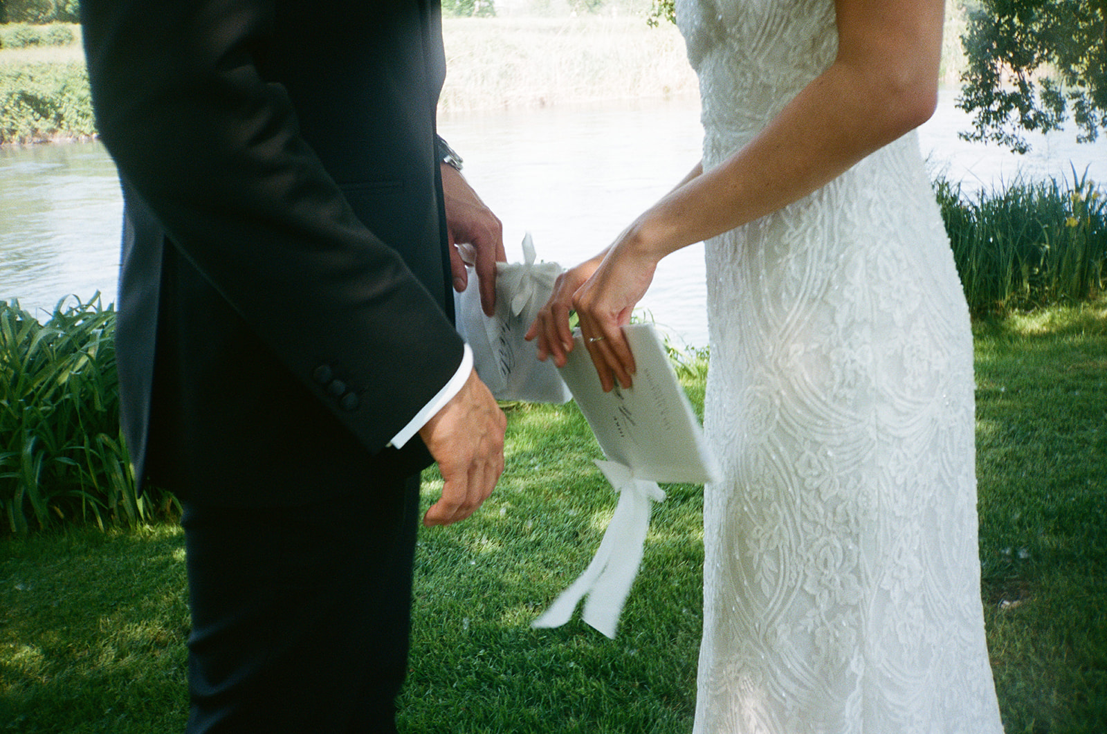 Intimate vow exchange captured on film by the river