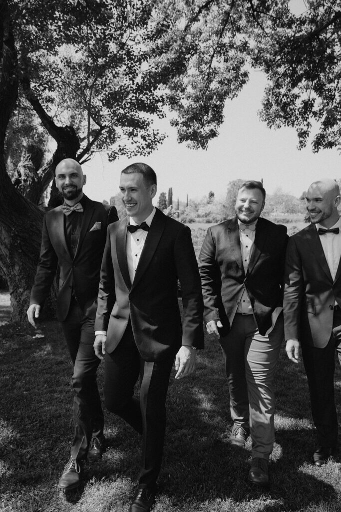 Candid black-and-white photo of groom and his groomsmen