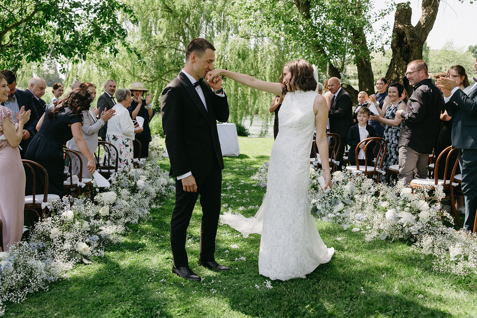 Newlyweds celebrating after ceremony aisle walk at La Finestra Sul Fiume