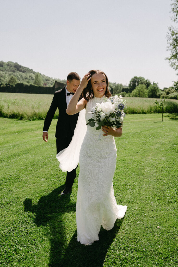 Candid moment of bride laughing with groom behind her after ceremony at La Finestra Sul Fiume