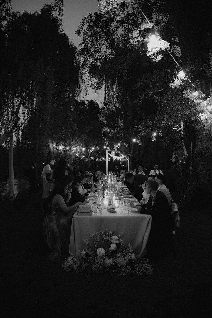 Candlelit reception under string lights at La Finestra Sul Fiume with guests dining
