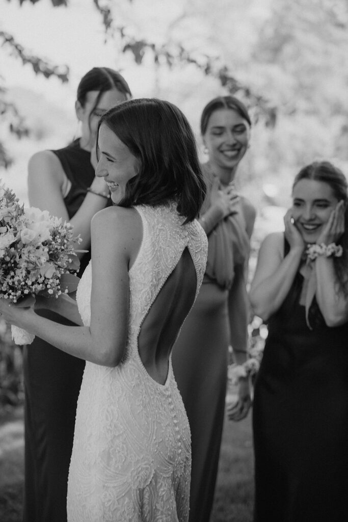 Candid first look moment with bride and bridesmaids