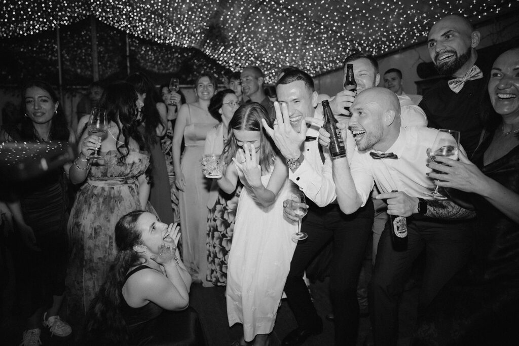 Bride and groom partying with guests during wedding reception